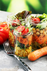 Homemade salad in glass jar with vegetables. Healthy food, diet, detox and clean eating
