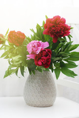 Beautiful Pink Red Peony Flowers Bouquet bunch Spring Composition in Ceramic Vase. Toned.