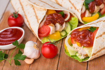 Tortilla wraps with grilled chicken and fresh vegetables