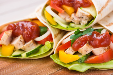 Tortilla wraps with grilled chicken and fresh vegetables