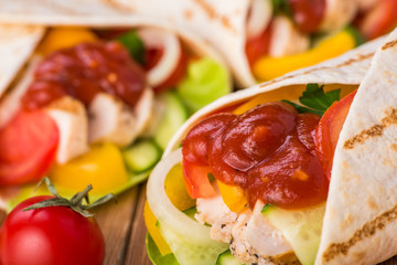 Tortilla wraps with grilled chicken and fresh vegetables