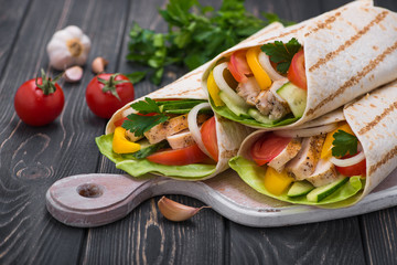 Tortilla wraps with grilled chicken and fresh vegetables