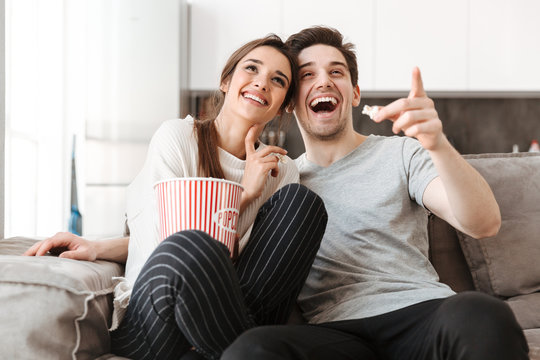 Portrait of a cheerful young couple relaxing on a couch