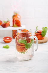 Detox infused water flavored with bloody orange and mint. Healthy refreshing beverage.