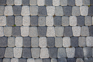 Fragment of stone pavement cobble-stones texture as a background