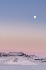 Full Moon and pastel skies in snowy Iceland
