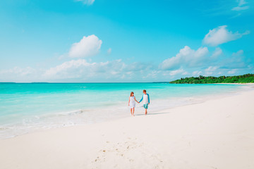 happy loving couple walking on beach