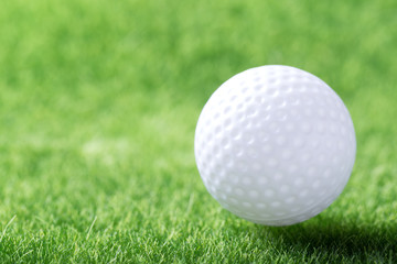 White golf ball on green grass background