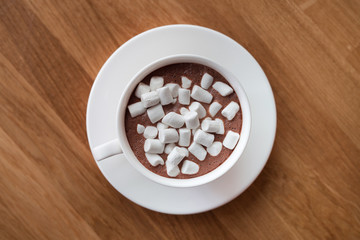 Fototapeta na wymiar White coffee cup with dessert marshmallow