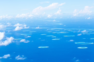 Aerial view from plane on sea and tropical islands, travel destinations