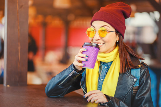 Hipster stylish woman drink takeaway hot coffee at outdoor cafe