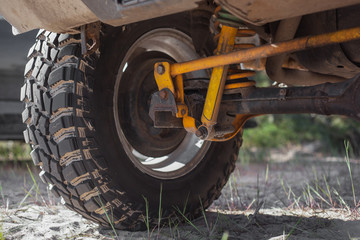 Studded SUV car tires with reinforced suspension on the sand