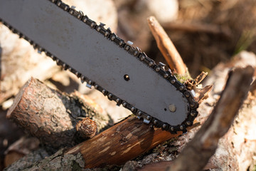 Chainsaw with an iron chain saws wood with a blurry background