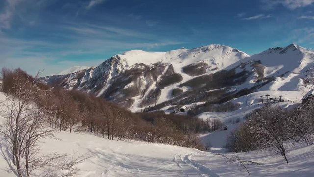 A skier skiing in mountains, action camera footage