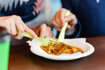 Woman eating dessert baklava in fast food restaurant