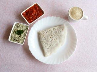 Neer dosa, a south Indian traditional, popular and vegetarian crepe or dish, with coconut and tomato chuntey as side dishes, and coffee.