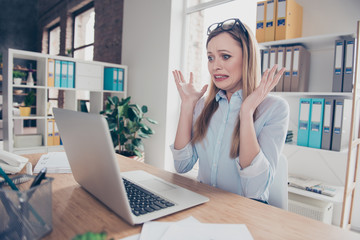 Portrait of charming, emotional, worried, nervous woman with glasses on head and hairstyle gesture...