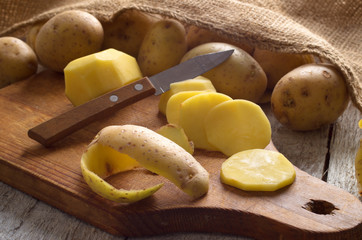 Fresh potatoes on an old wooden table