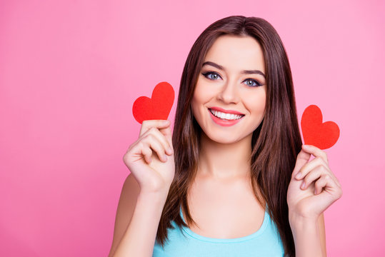 Just open your heart! Close up of playful beautiful pretty lovely cute charming excited cheerful joyful adorable with straight haircut woman demonstrating two red hearts, isolated on pink background