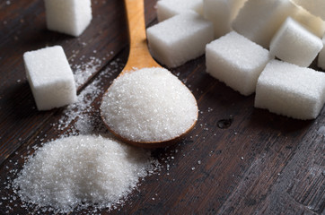 Fototapeta na wymiar white sugar on wood table