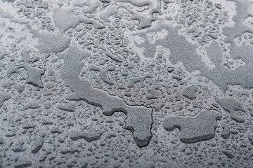 Wassertropfen auf dunkler Oberfläche 