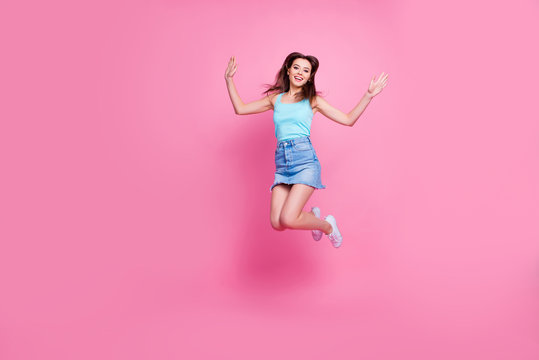 Full-size full-length portrait of beautiful attractive excited adorable lovely girl wearing blue t-shirt singlet jumping up to the stars, isolated om pink background, copyspace