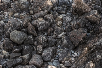 Closeup of black coal lumps. Heap of dark stones. Close up stone texture, Crushed stone, railway ballast, gray patttern background, high resolution seamless texture, concrete, uneven cement