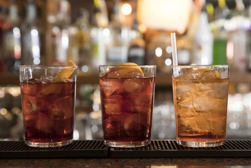three cocktails on the bar counter