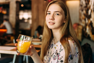 Beautiful girl with Cup in cafe, resting, work break
