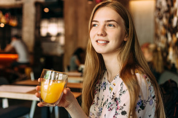 Beautiful girl with Cup in cafe, resting, work break