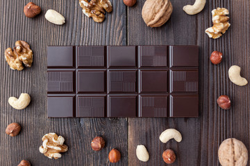 Delicious dark chocolate on wooden background