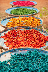 Colourful incense sticks on baskets for natural drying.