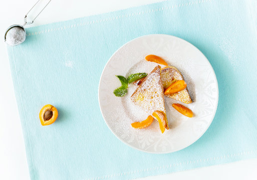 French toasts with fresh cut apricot, mint and icing powder. Healthy classic breakfast concept. Top view.