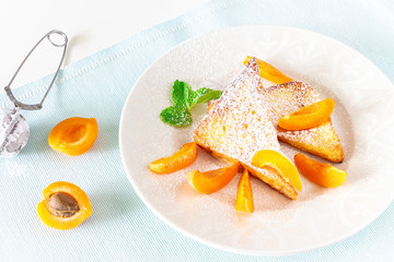 French toasts with fresh cut apricot, mint and icing powder. Healthy classic breakfast concept. Top view.