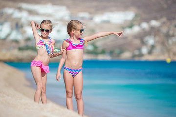 Two little girls together on the beach on vacation