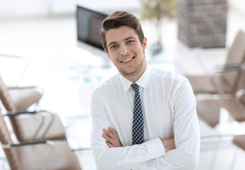 confident young businessman on background of office
