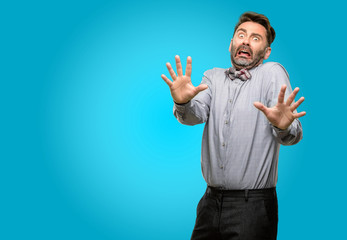 Middle age man, with beard and bow tie disgusted and angry, keeping hands in stop gesture, as a...