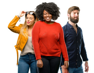 Group of three young men and women blinking eyes with happy gesture