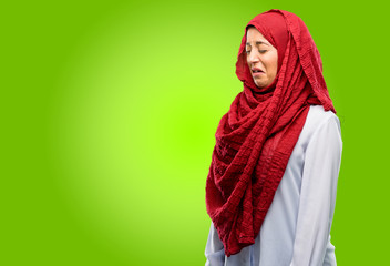 Young arab woman wearing hijab crying depressed full of sadness expressing sad emotion