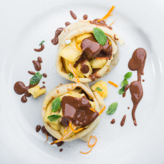 Delicious pancakes with bananas and pineapples