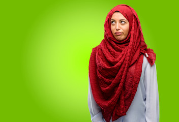 Young arab woman wearing hijab making funny face fooling