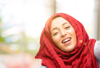 Young arab woman wearing hijab confident and happy with a big natural smile welcome gesture