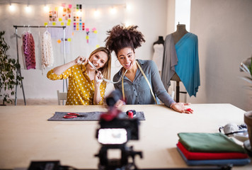 A camera and a slider with women in the background, startup business.