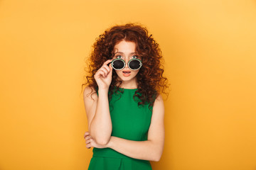 Portrait of a shocked redhead woman in dress