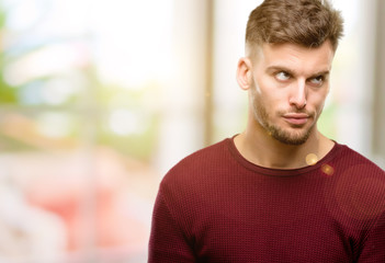 Handsome young man making funny face fooling