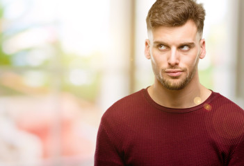 Obraz premium Handsome young man making funny face fooling
