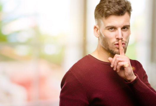 Handsome Young Man With Index Finger On Lips, Ask To Be Quiet. Silence And Secret Concept