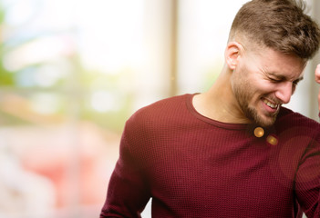 Handsome young man happy and excited celebrating victory expressing big success, power, energy and positive emotions. Celebrates new job joyful