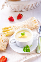 asparagus cream soup with capers and fresh baguette