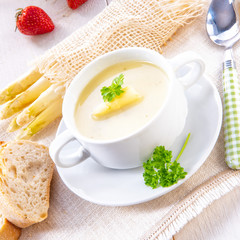 asparagus cream soup with capers and fresh baguette